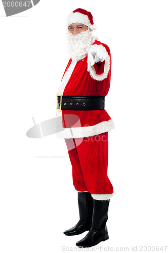 Image of Senior man in Santa costume pointing at you