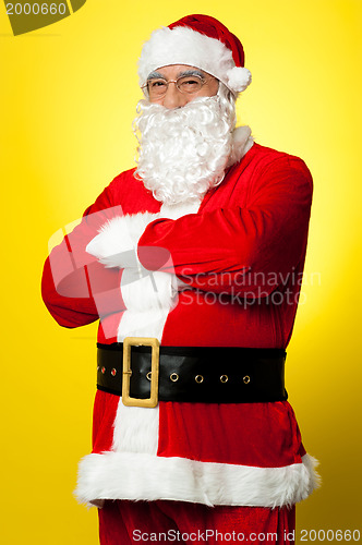 Image of Confident male Santa posing with arms folded