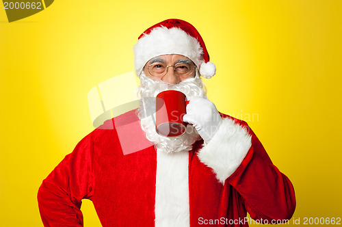 Image of Relaxed Santa enjoying his cup of coffee