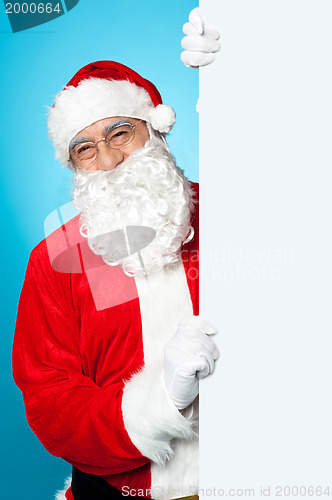 Image of Santa posing beside long blank banner ad