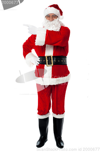 Image of Father Santa pointing towards the copy space area