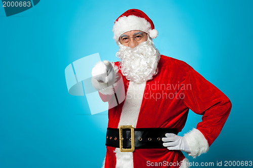 Image of Handsome man in Santa costume pointing at you