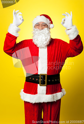 Image of Aged Santa gesturing perfect sign with both hands