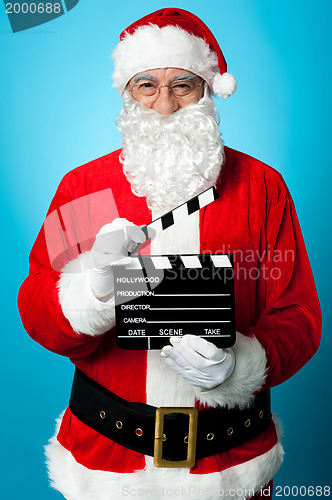 Image of Bespectacled Santa holding a clapperboard
