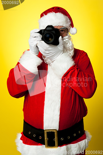 Image of Smile please! Santa capturing a perfect frame