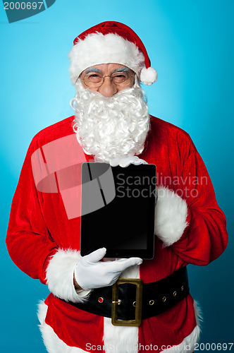 Image of Father Christmas presenting a new tablet device