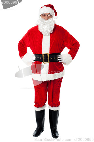 Image of Cheerful Santa Claus posing with hands on waist