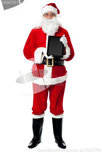 Image of Saint Nicholas displaying a brand new tablet device