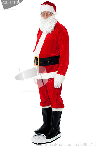 Image of Health conscious Santa checking his weight