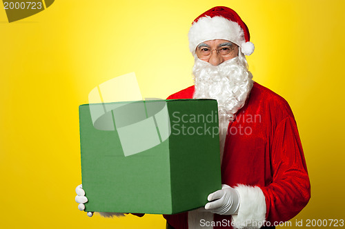 Image of Santa Claus delivering big green gift box