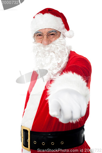 Image of Elderly cheerful Santa pointing at you