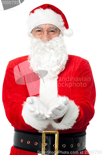 Image of Bespectacled Father Santa posing with open palms