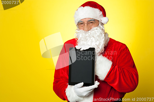 Image of Santa Claus holding newly launched tablet device