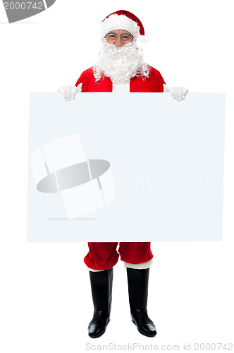 Image of Saint Nicholas standing behind blank whiteboard