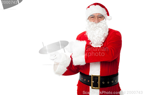 Image of Santa pointing at blank copy space area