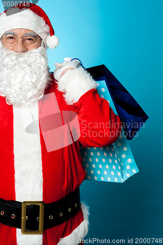 Image of Saint Nicholas carrying colorful shopping bags