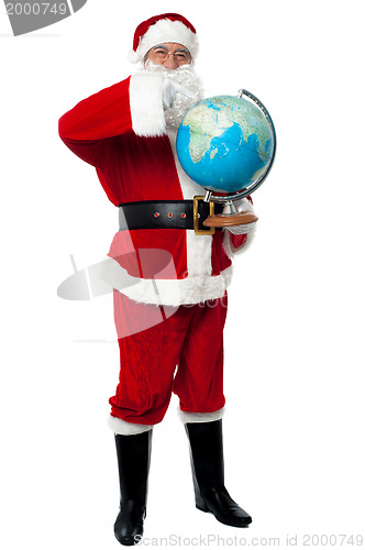 Image of Santa pointing out a continent on globe