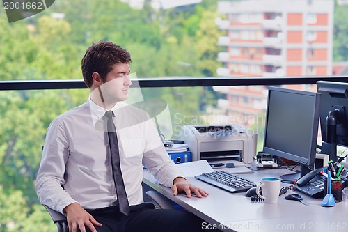 Image of happy young business man at office