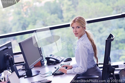 Image of business woman working on her desk in an office