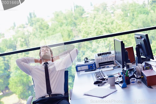Image of happy young business man at office