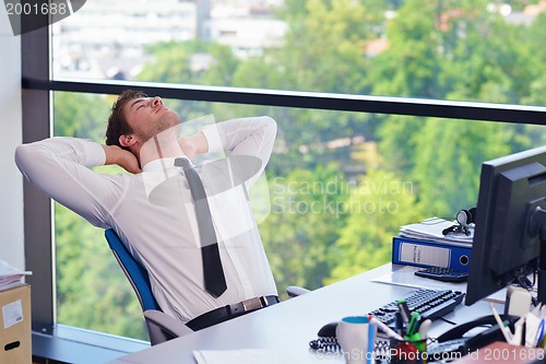 Image of happy young business man at office