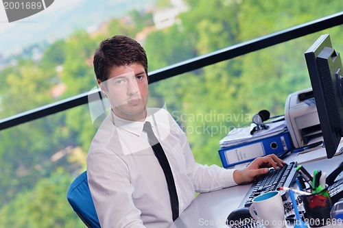 Image of happy young business man at office
