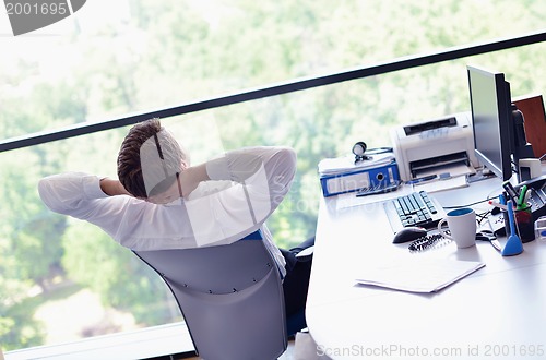 Image of happy young business man at office