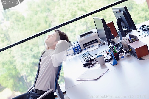 Image of happy young business man at office