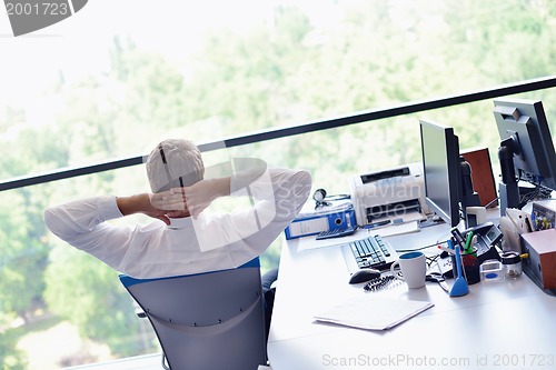 Image of happy young business man at office