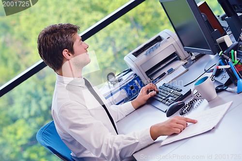 Image of happy young business man at office