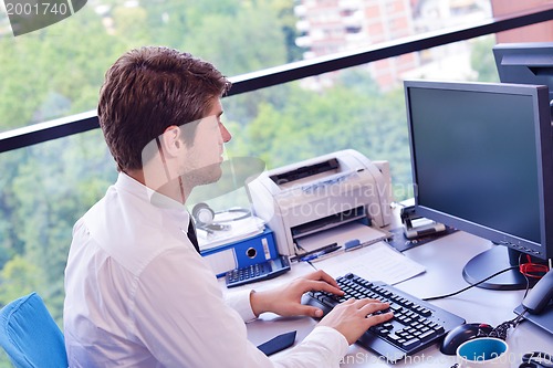 Image of happy young business man at office