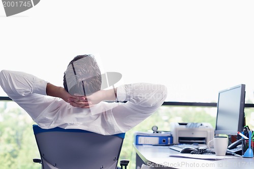 Image of happy young business man at office