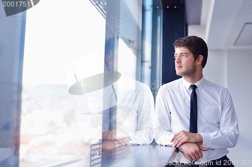 Image of happy young business man at office