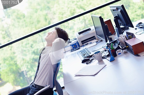 Image of happy young business man at office
