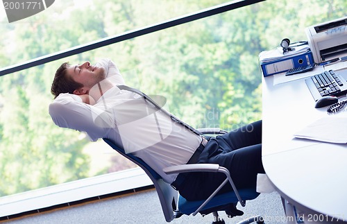 Image of happy young business man at office