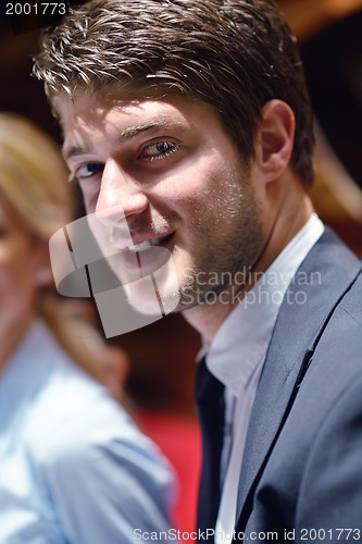 Image of happy young business man at office