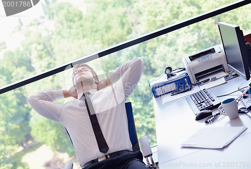 Image of happy young business man at office