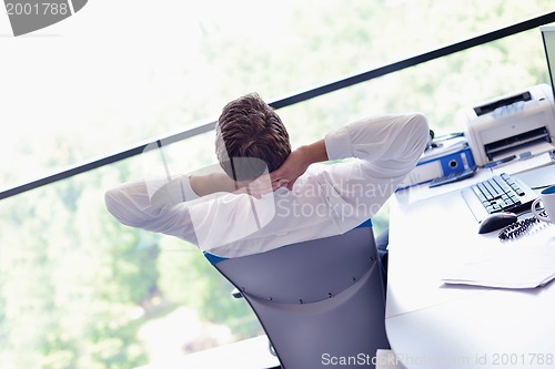 Image of happy young business man at office