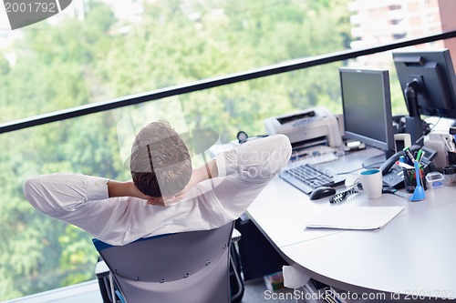 Image of happy young business man at office