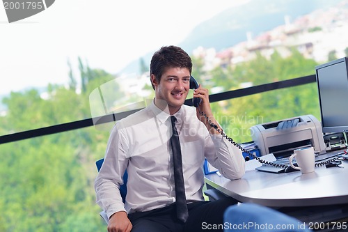Image of happy young business man at office