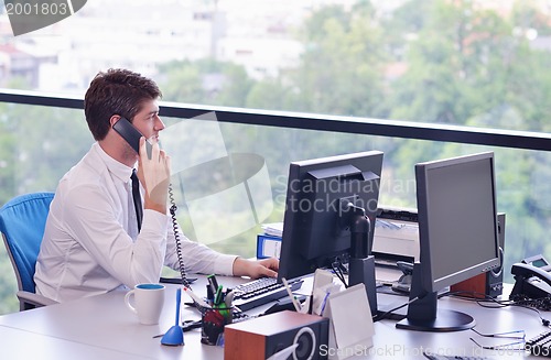 Image of happy young business man at office
