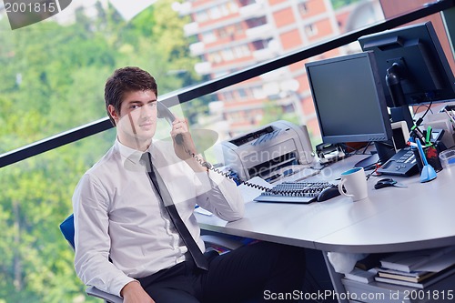 Image of happy young business man at office