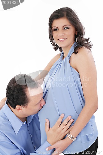 Image of Father kissing pregnant belly of wife. Concept of love, over whi