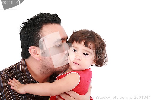 Image of Father hugging and kissing little daughter, smiling. 