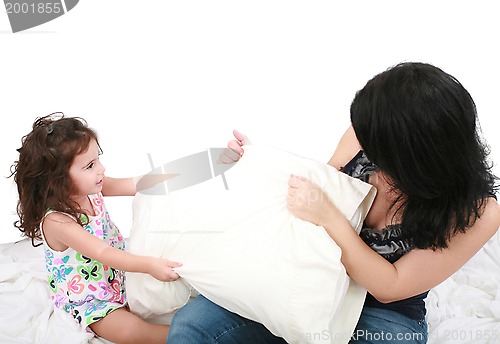 Image of mother and daughter having fun with pillows