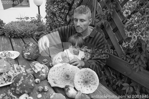 Image of Father and Daughter happy with a table full of Boletus Mushrooms