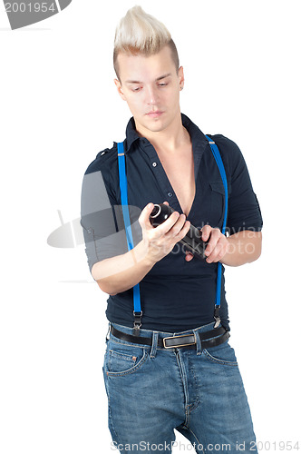 Image of Handsome man in jeans and suspenders