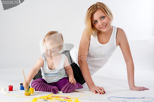 Image of Pretty young mother and daughter drawing