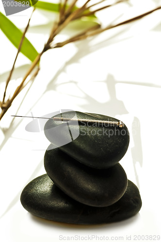 Image of acupuncture needle on stone