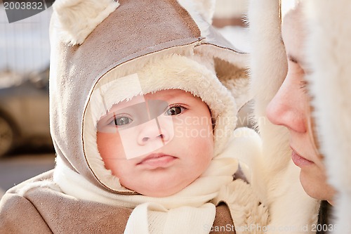 Image of Mother with baby in winter